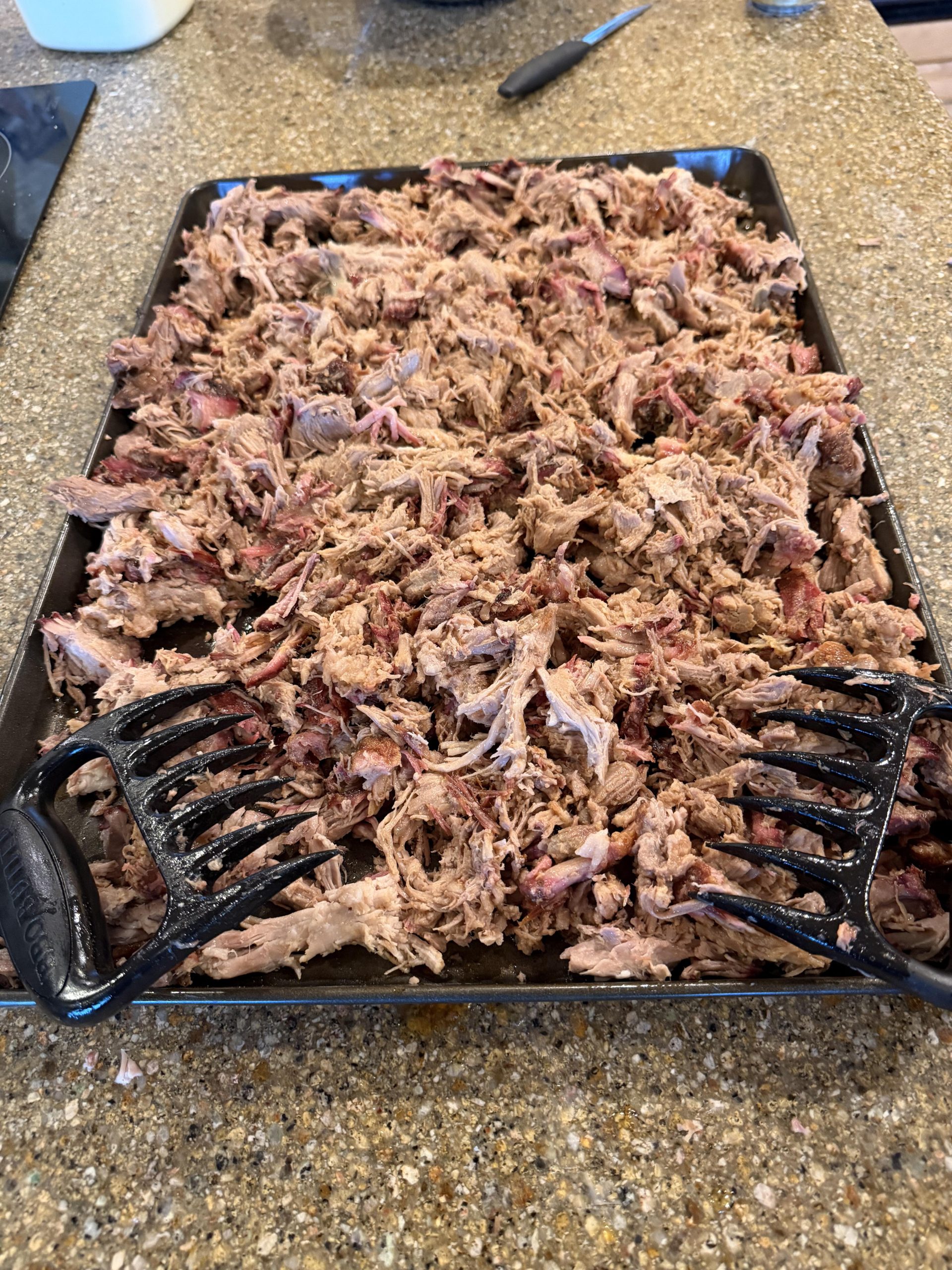 Freshly pulled smoked pork on a sheet pan