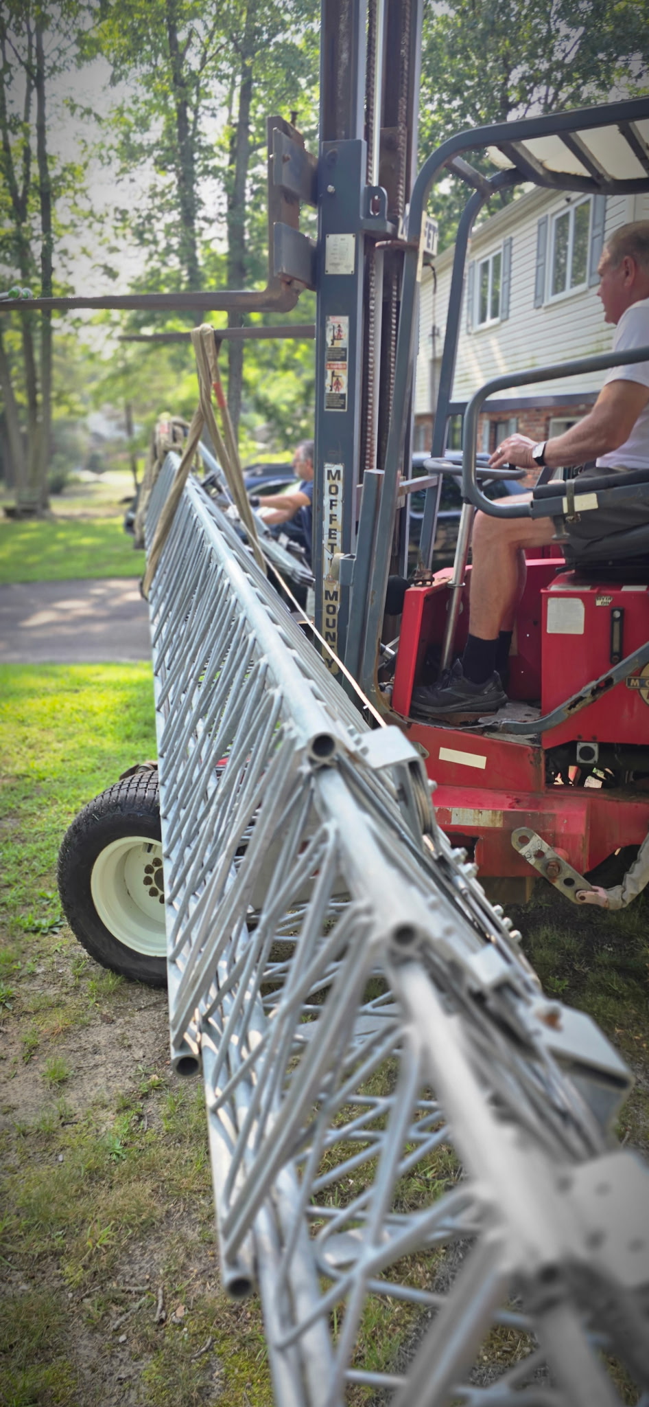 Mike operating the Moffett forklift alongside a tower section on the ground