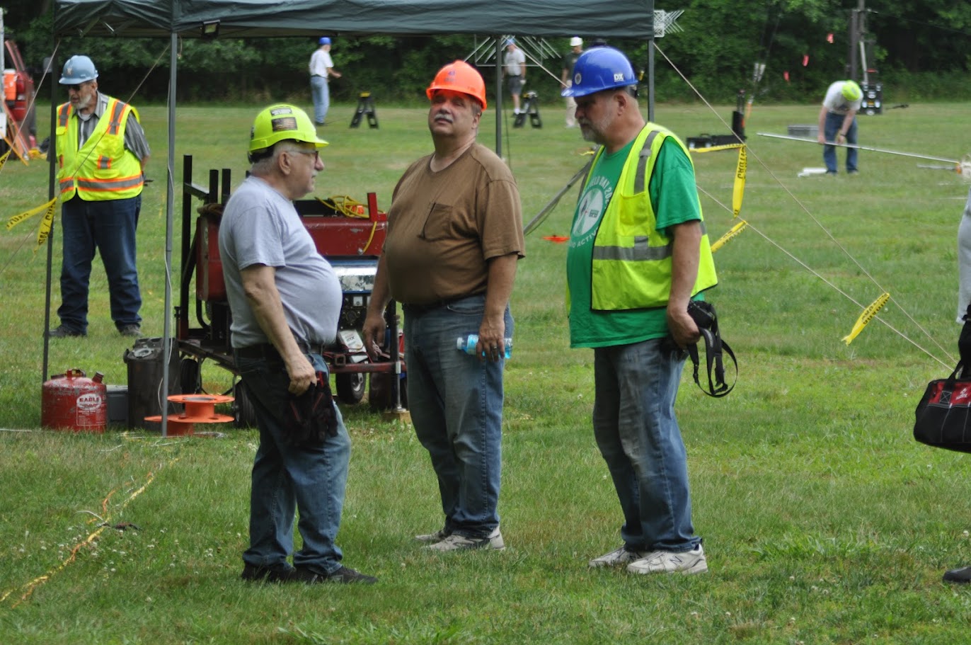 Carl, Joe, and Ken strategizing on the field