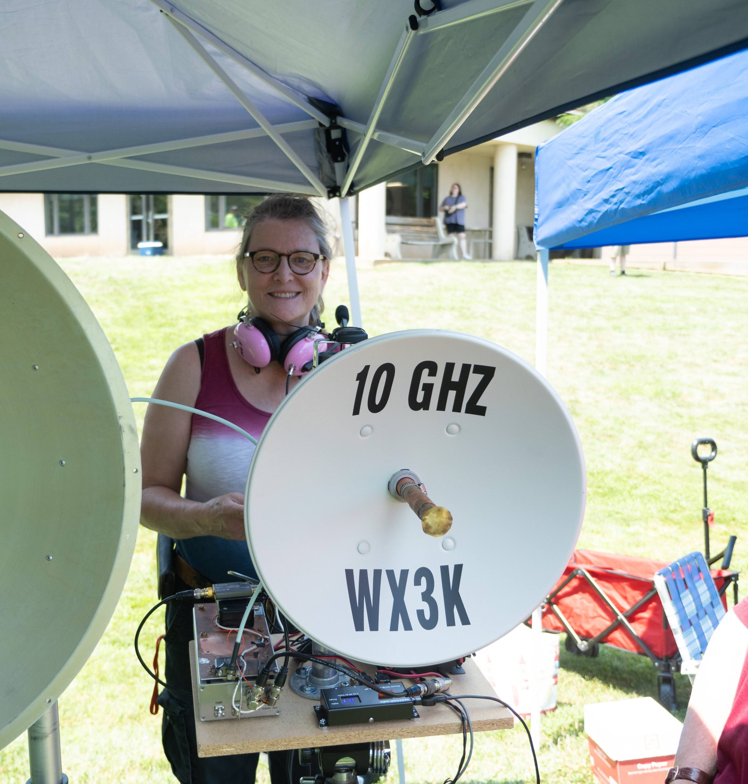Stephanie WX3K standing behind her labeled 10 GHz dish